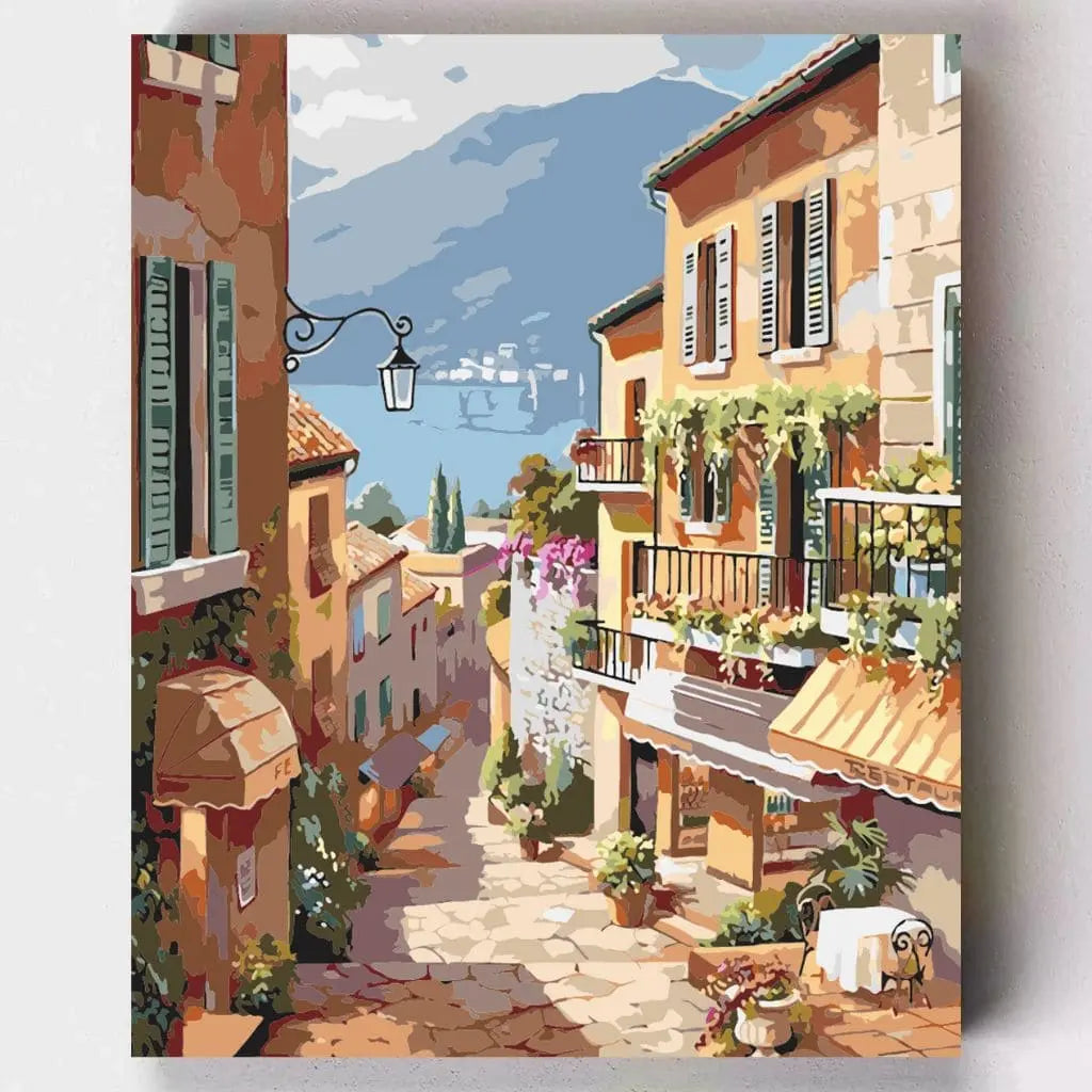 DIY Malen nach Zahlen – Sonnenverwöhnte italienische Gasse mit Blick auf den See & blühenden Balkonen auf Leinwand malen – für Urlaubsstimmung & kreative Entspannung – nur bei Artyroom.shop